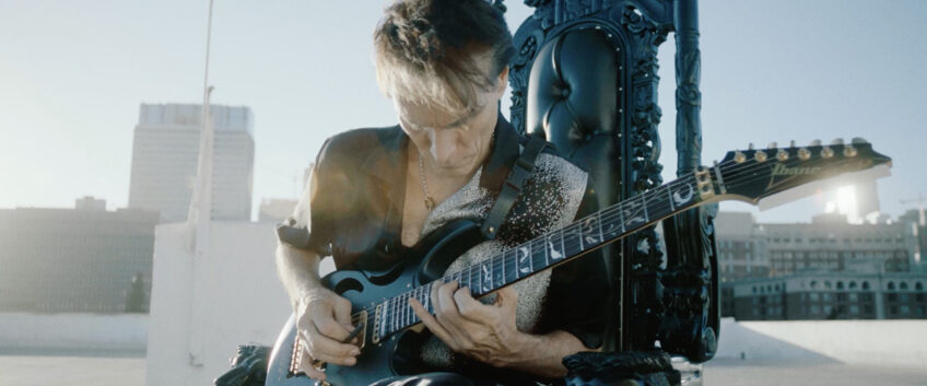 Steve Vai, the guitar maestro, playing a 7-string Ibanez in Polyphia's "Ego Death" music video.