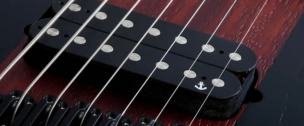 Detailed view of the pickups on Rob Scallon's Schecter 7-string guitar, highlighting the precision engineering.